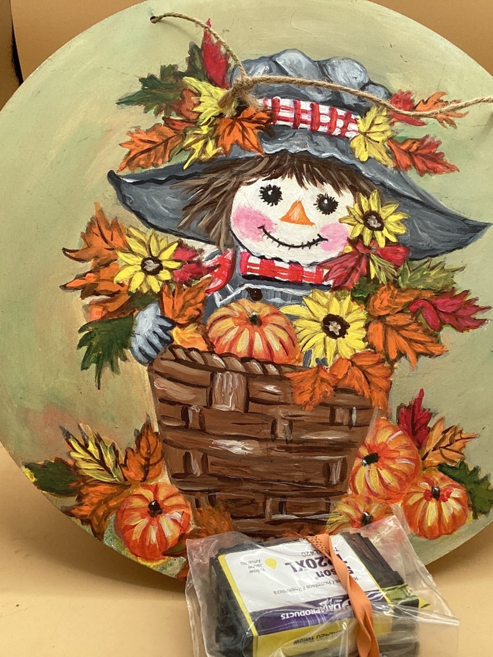 Painted scarecrow with autumn objects